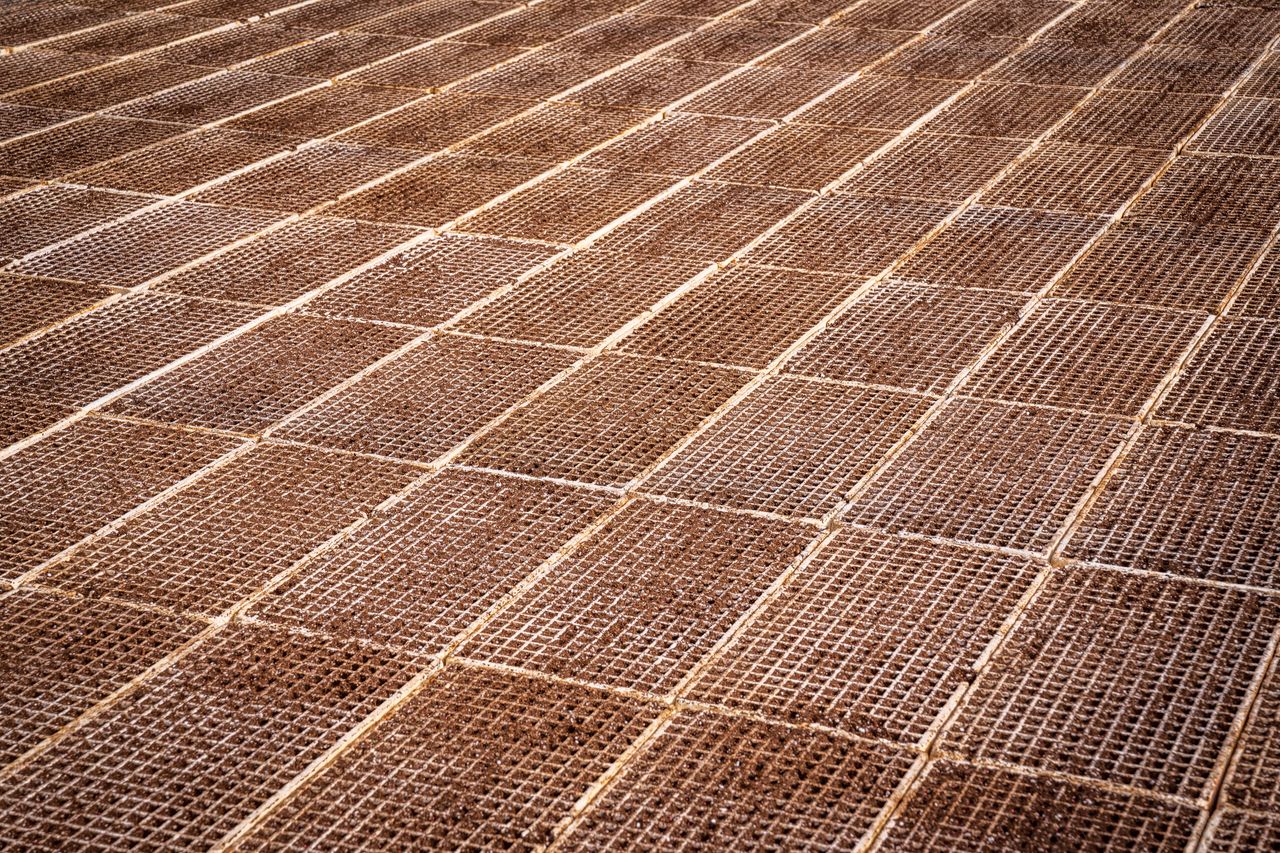 about-us Close-up view of textured steel mesh grid pattern. Ideal for construction industry concepts.